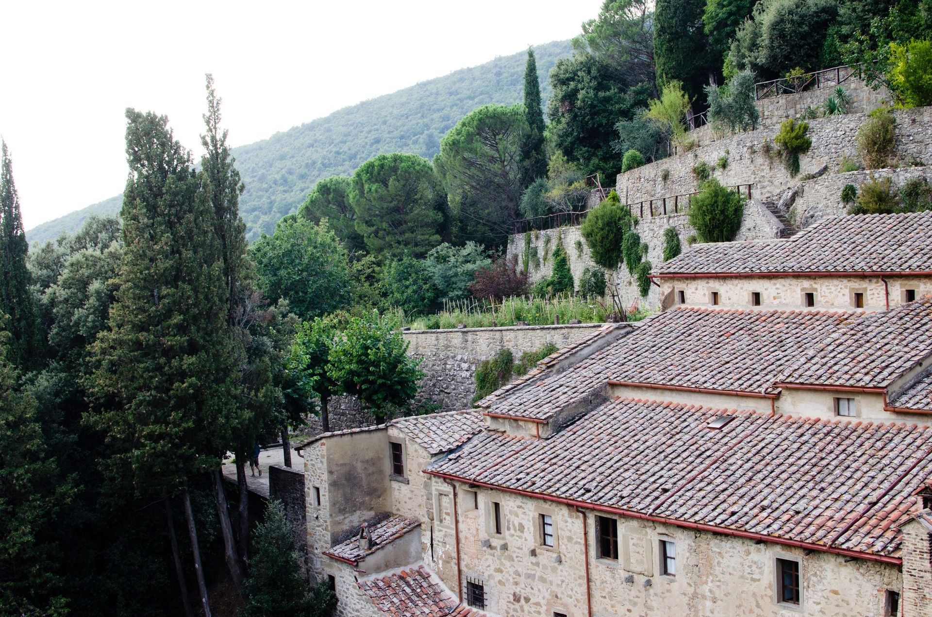 The monastery of Le Celle near Cortona in the Tuscan hills under an open sky.